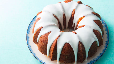 Butter Pound Cake with Vanilla Glaze on a Blue and White Plate with a Turquoise background