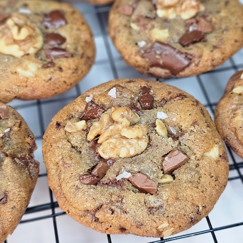 Close up of chocolate walnut cookies on a wire cookie rack. 