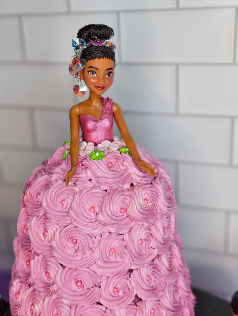 Close up of princess Barbie cake, with pink buttercream dress. 